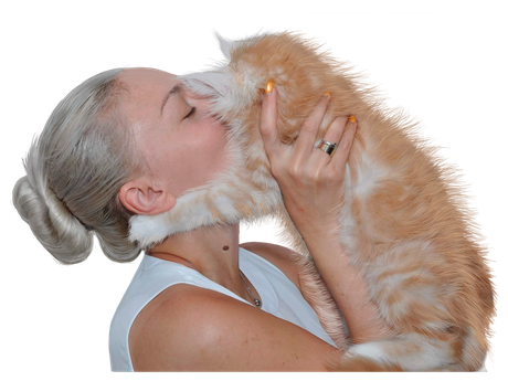 A woman kissing an orange cat on the cheek.